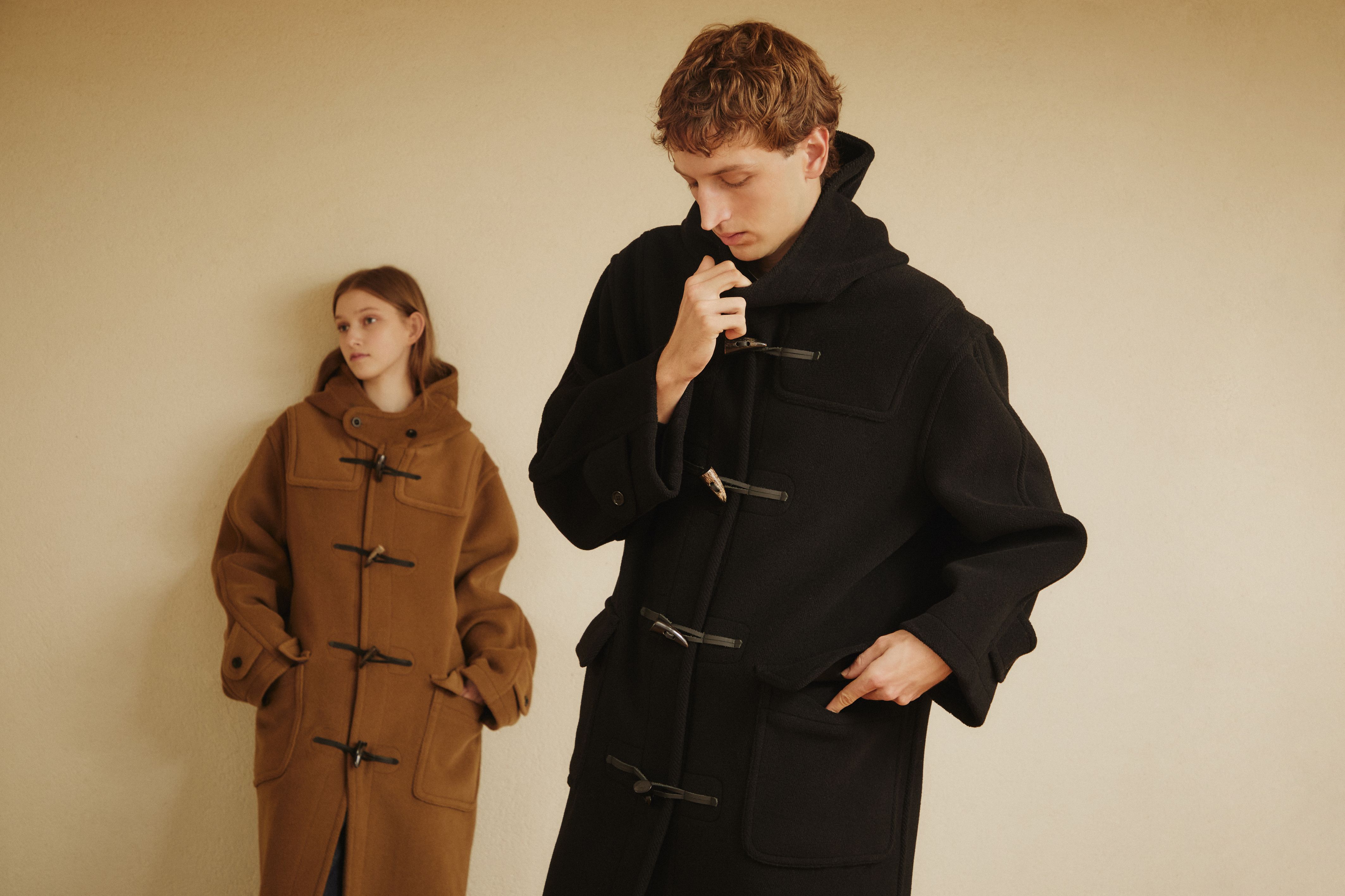 Two models wearing camel and black GLENMORE duffle coats