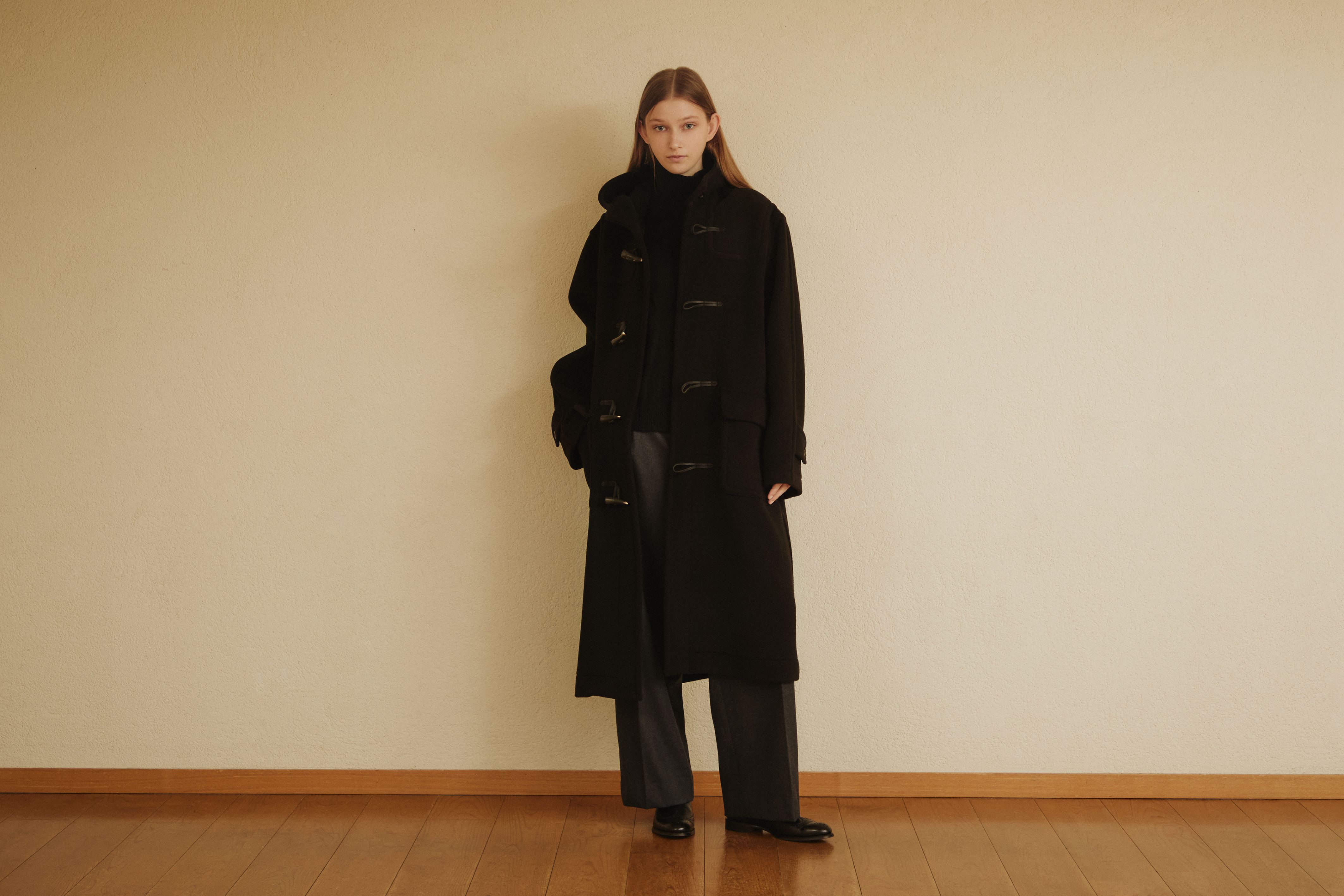 Model wearing a black GLENMORE duffle coat