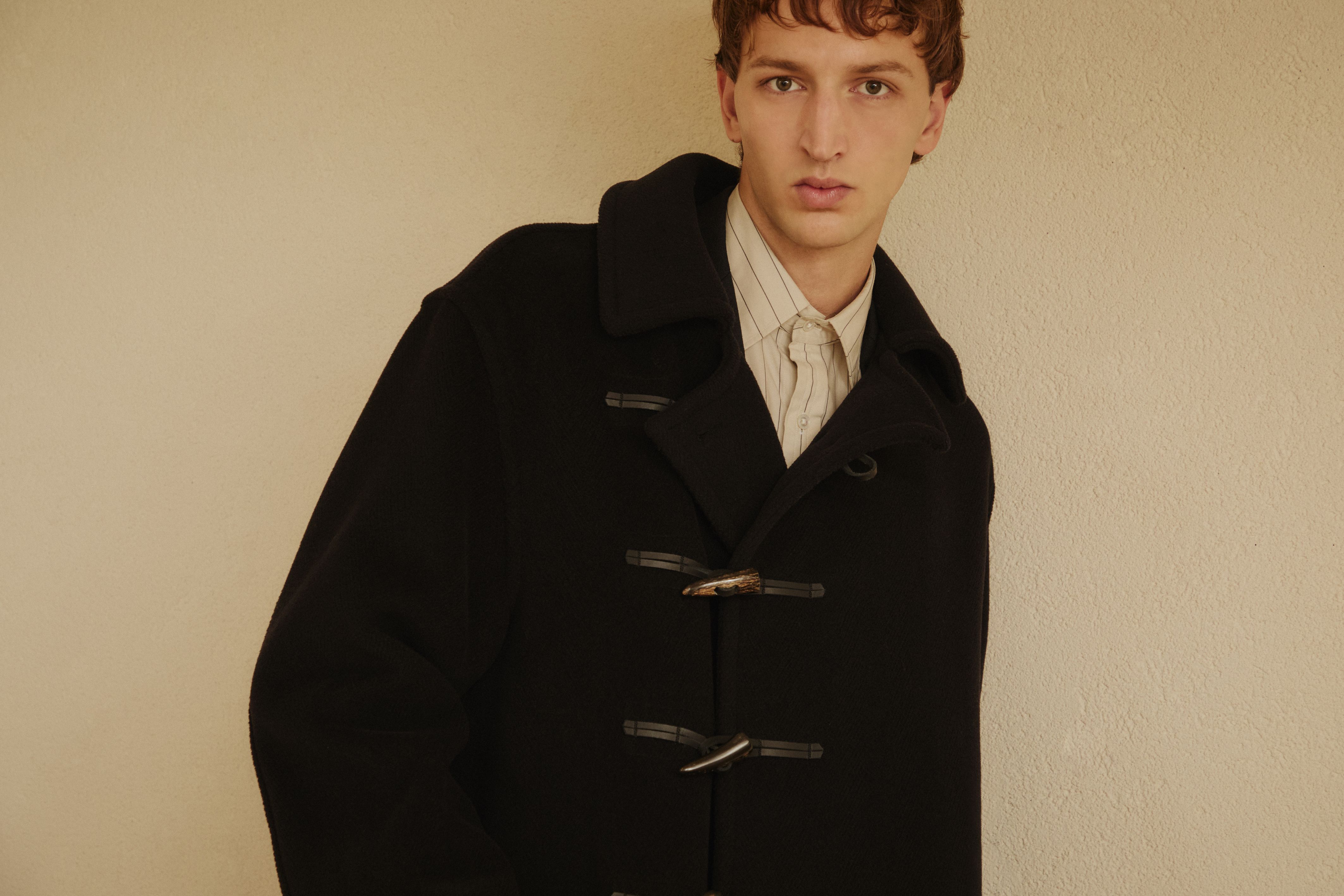 Model wearing a black GLENMORE duffle coat